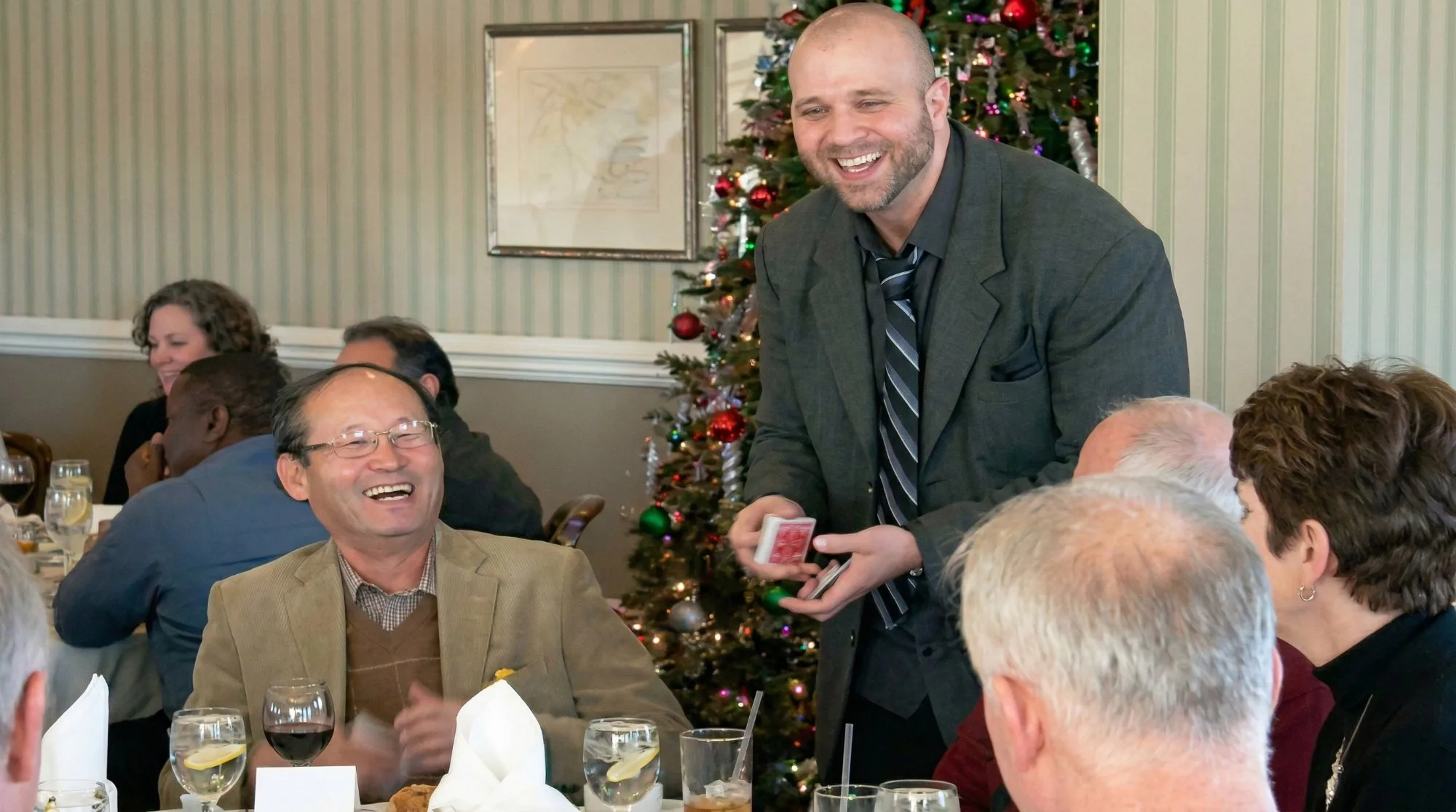Mike DiDomenico performing close-up magic at corporate holiday event